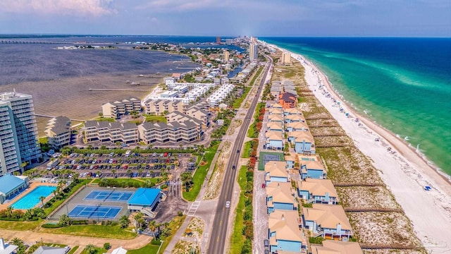 birds eye view of property featuring a beach view and a water view