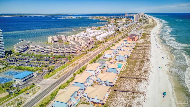 drone / aerial view featuring a water view and a view of the beach