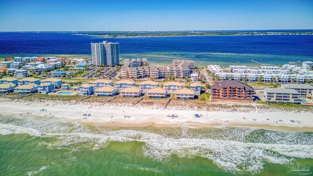 drone / aerial view with a water view and a beach view