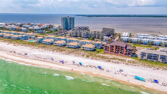 drone / aerial view with a water view and a beach view