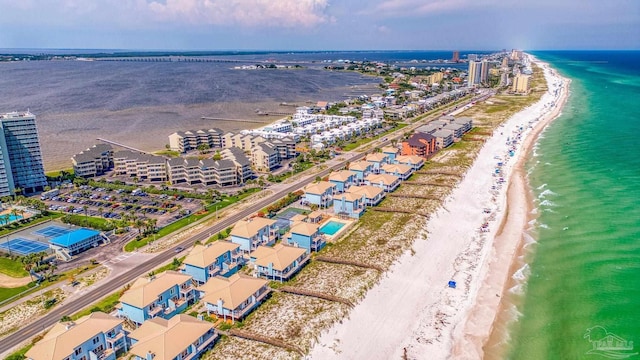 drone / aerial view with a water view and a beach view