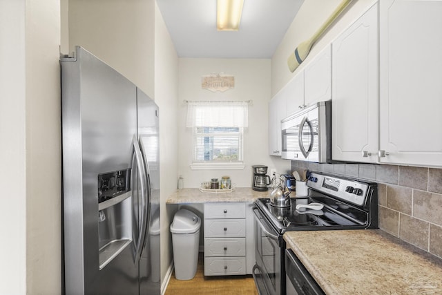 kitchen featuring backsplash, white cabinets, and appliances with stainless steel finishes