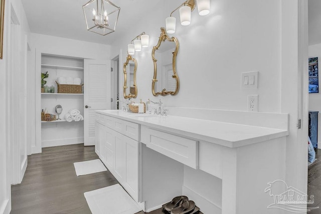 6050 Cheyenne Dr, Milton, FL 32570 - full bath featuring wood finished floors, double vanity, and a chandelier