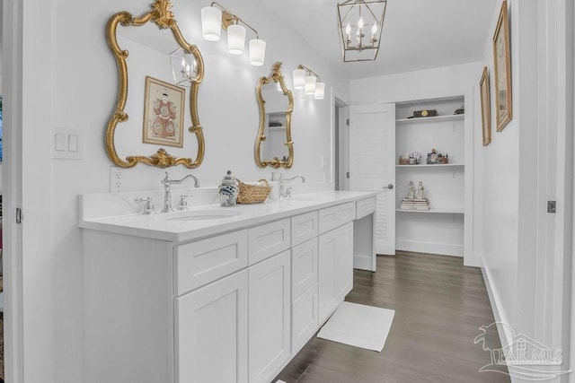 6050 Cheyenne Dr, Milton, FL 32570 - bathroom with double vanity, wood finished floors, and a chandelier