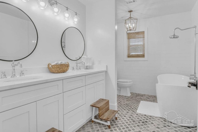 6050 Cheyenne Dr, Milton, FL 32570 - bathroom featuring double vanity, a soaking tub, a chandelier, toilet, and a shower