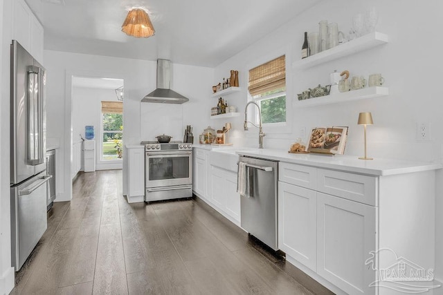 6050 Cheyenne Dr, Milton, FL 32570 - kitchen featuring open shelves, stainless steel appliances, wall chimney range hood, a sink, and plenty of natural light