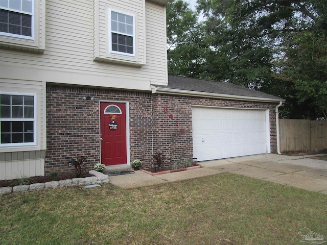 view of front of property featuring a garage and a front lawn