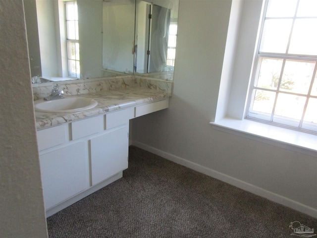 bathroom featuring plenty of natural light and vanity