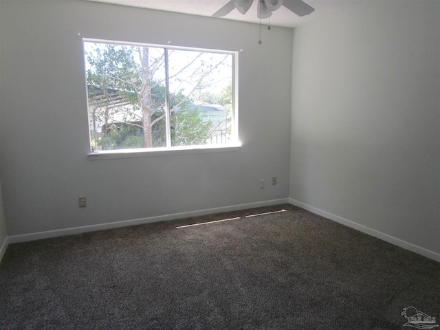 carpeted spare room with ceiling fan and plenty of natural light