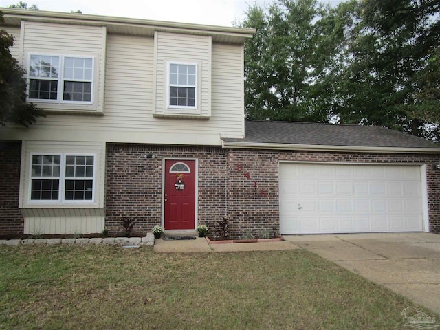 view of front of house featuring a garage and a front lawn