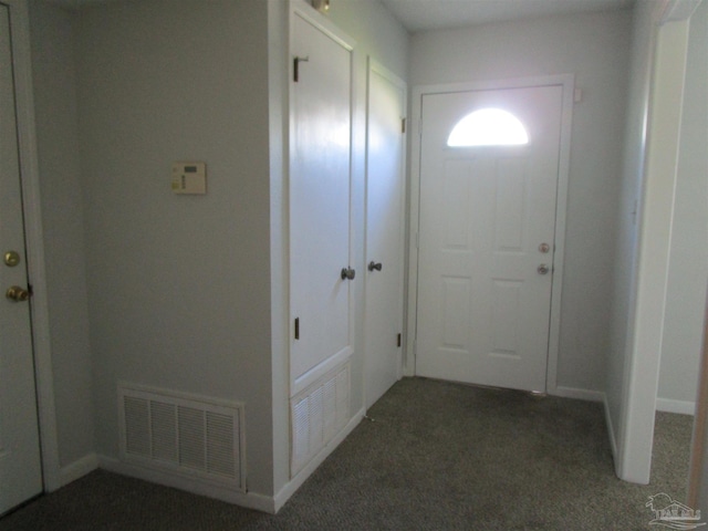 doorway to outside featuring dark colored carpet