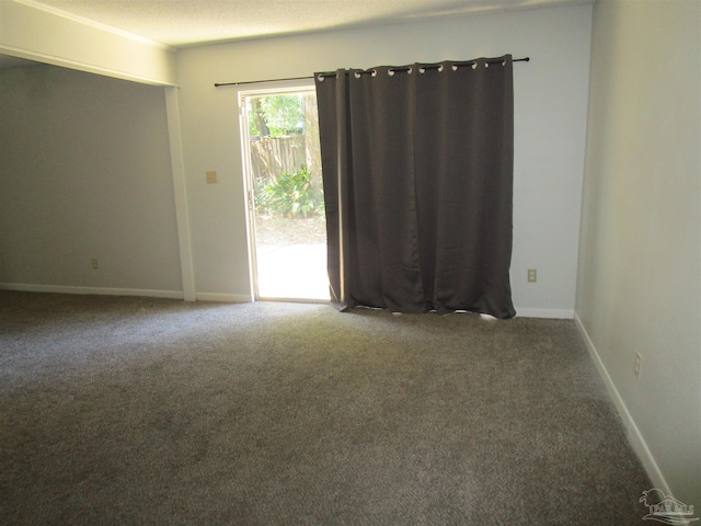 unfurnished room with carpet floors and a textured ceiling