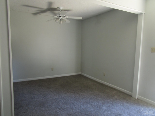 carpeted spare room with a textured ceiling and ceiling fan