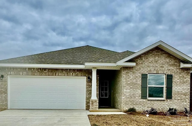 1636 Slate Dr, Cantonment, FL 32533 - ranch-style home featuring a shingled roof, driveway, a garage, and brick siding