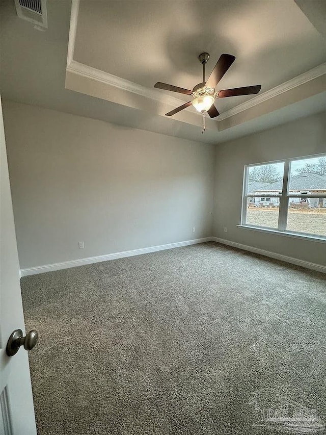 1636 Slate Dr, Cantonment, FL 32533 - carpeted spare room featuring a tray ceiling, ornamental molding, ceiling fan, and baseboards