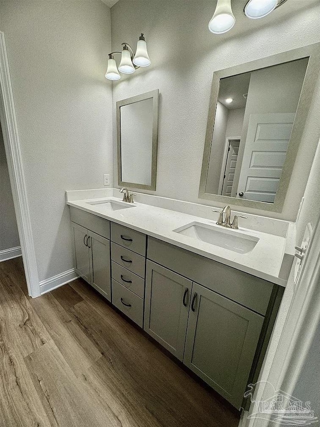 1636 Slate Dr, Cantonment, FL 32533 - full bathroom featuring wood finished floors, double vanity, and baseboards