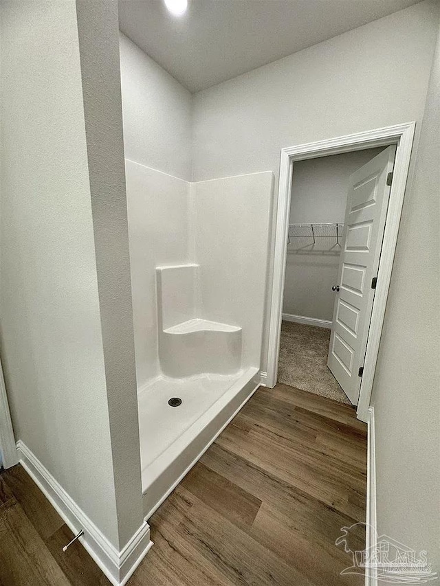 1636 Slate Dr, Cantonment, FL 32533 - full bathroom with wood finished floors, a shower stall, baseboards, and a spacious closet