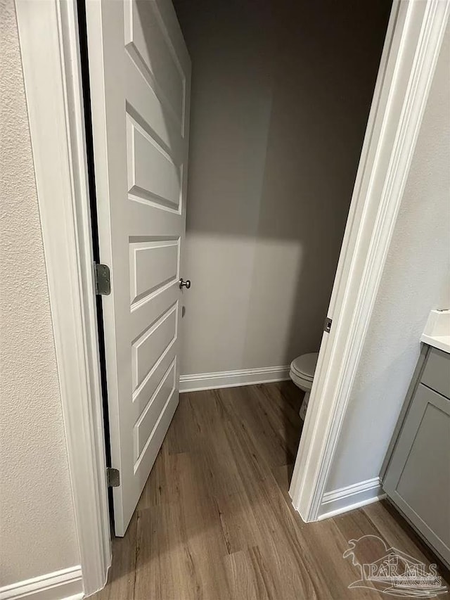 1636 Slate Dr, Cantonment, FL 32533 - bathroom featuring wood finished floors, baseboards, toilet, and vanity