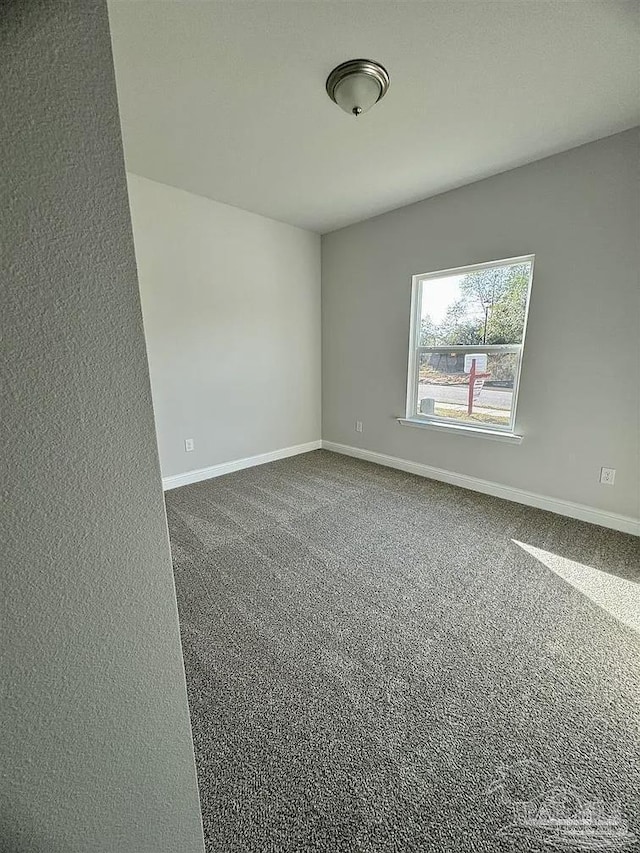1636 Slate Dr, Cantonment, FL 32533 - spare room with baseboards and dark colored carpet
