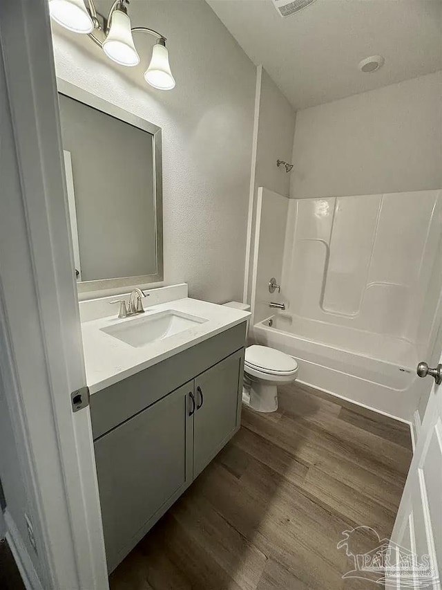 1636 Slate Dr, Cantonment, FL 32533 - bathroom with wood finished floors, toilet, bathtub / shower combination, and vanity
