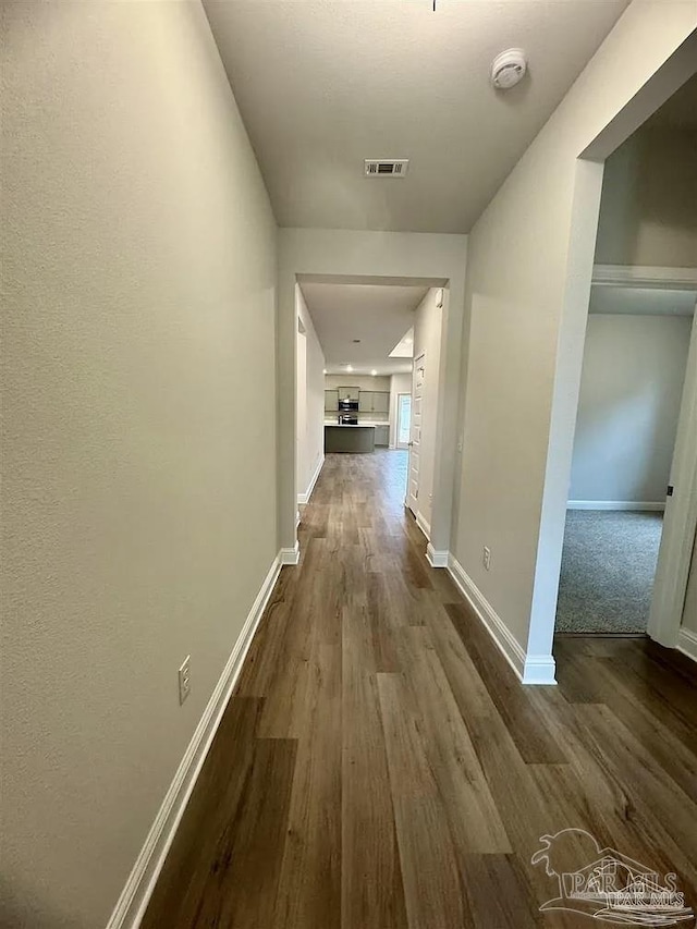 1636 Slate Dr, Cantonment, FL 32533 - hallway featuring dark wood-type flooring and baseboards