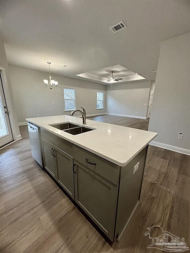 1636 Slate Dr, Cantonment, FL 32533 - kitchen with a sink, stainless steel dishwasher, dark wood finished floors, a center island with sink, and gray cabinets