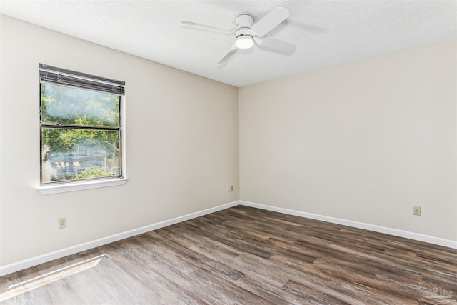 unfurnished room with baseboards, a ceiling fan, a textured ceiling, and wood finished floors