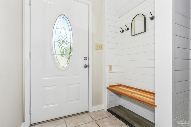 foyer with light tile patterned floors and baseboards