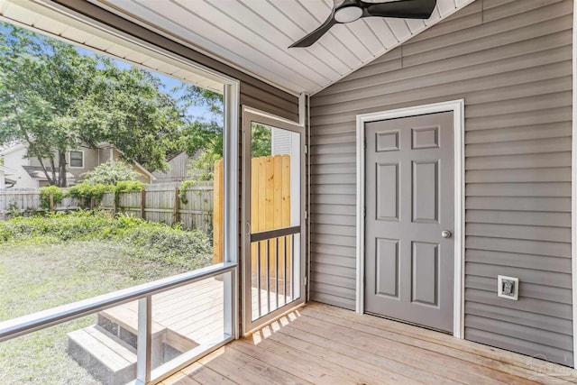 unfurnished sunroom with a ceiling fan