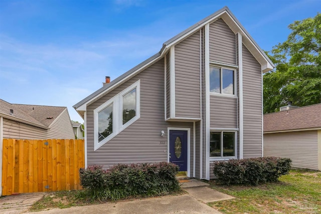 view of front of property featuring fence