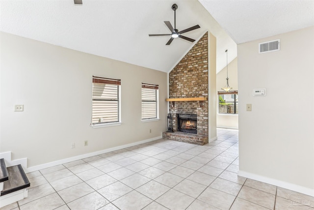 unfurnished living room featuring visible vents, plenty of natural light, ceiling fan, and high vaulted ceiling