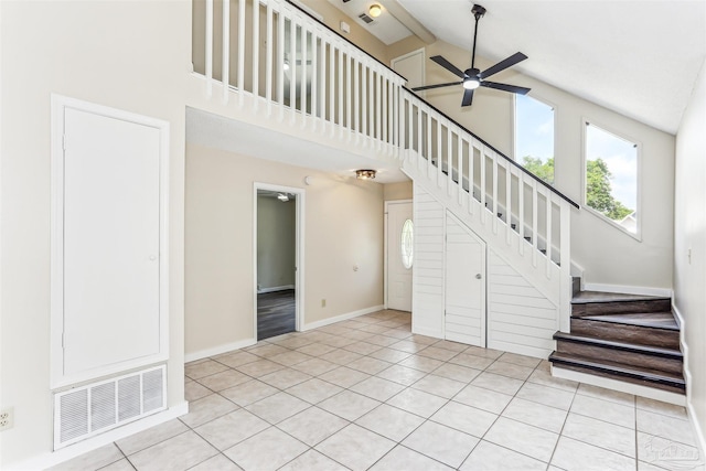 unfurnished living room featuring stairway, ceiling fan, visible vents, and a healthy amount of sunlight