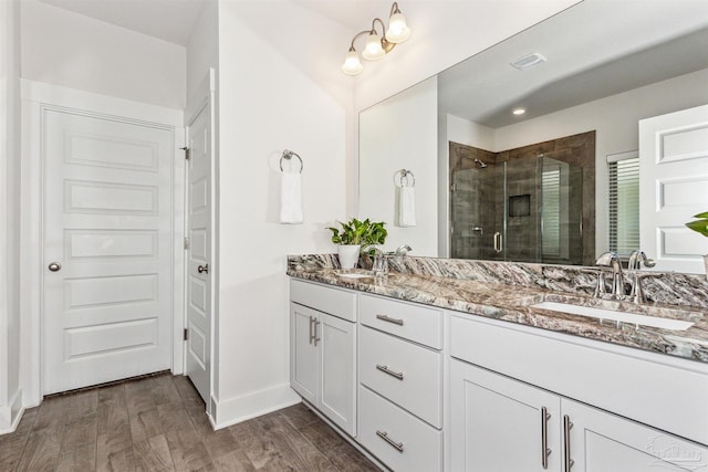 bathroom featuring vanity and a shower with door