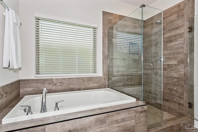 bathroom with separate shower and tub