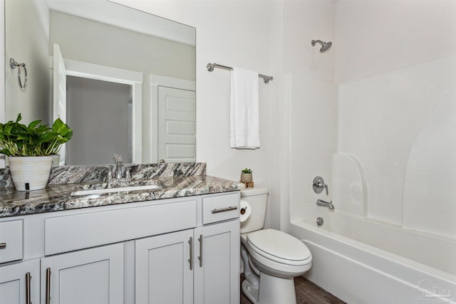 full bathroom featuring hardwood / wood-style floors, vanity, toilet, and bathing tub / shower combination