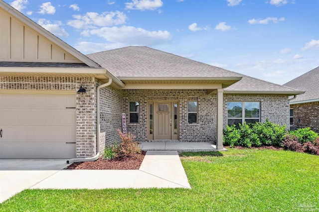 property entrance with a lawn, a porch, and a garage