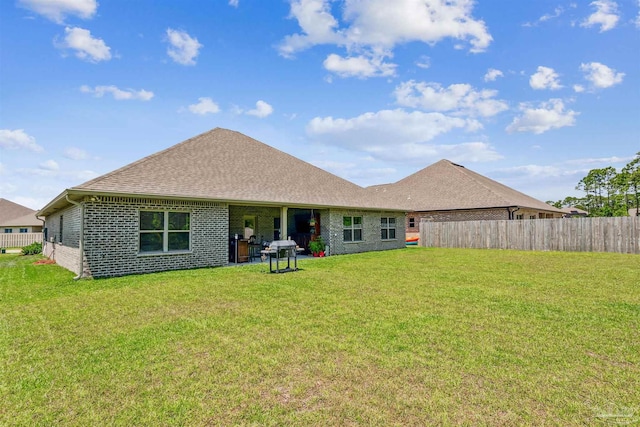 back of house with a yard