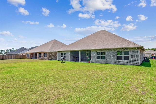 rear view of property with a yard