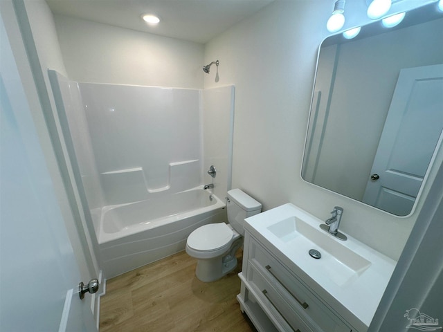 full bath featuring toilet, shower / washtub combination, wood finished floors, and vanity