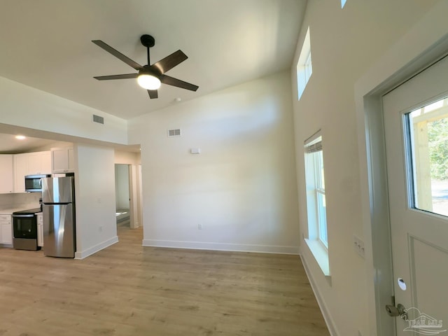 unfurnished living room featuring light wood-type flooring, visible vents, and baseboards