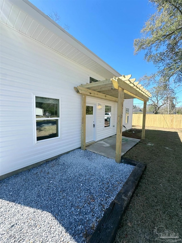 view of patio / terrace featuring fence and a pergola