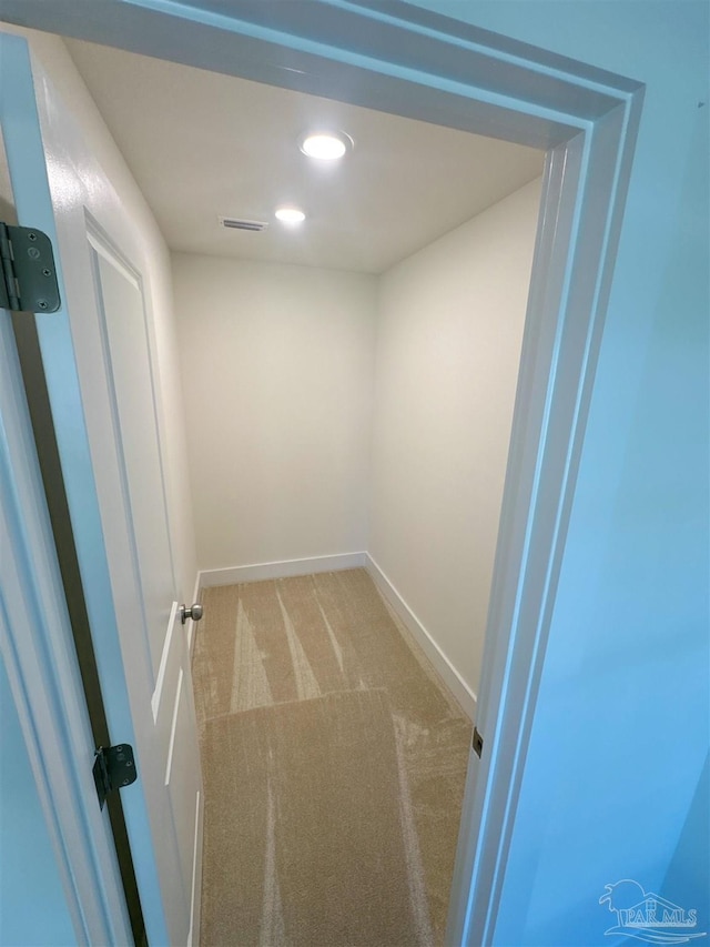 hall with recessed lighting, baseboards, and light colored carpet