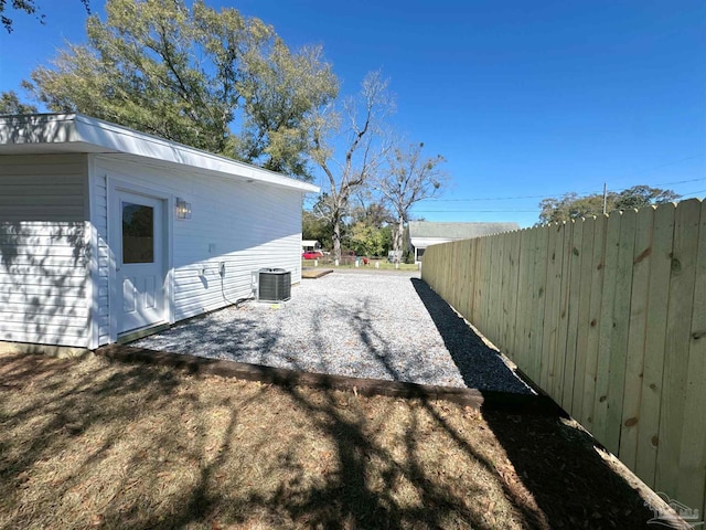 view of home's exterior featuring central AC, fence, and a patio