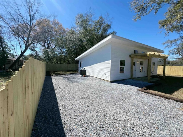 view of property exterior with cooling unit and a fenced backyard