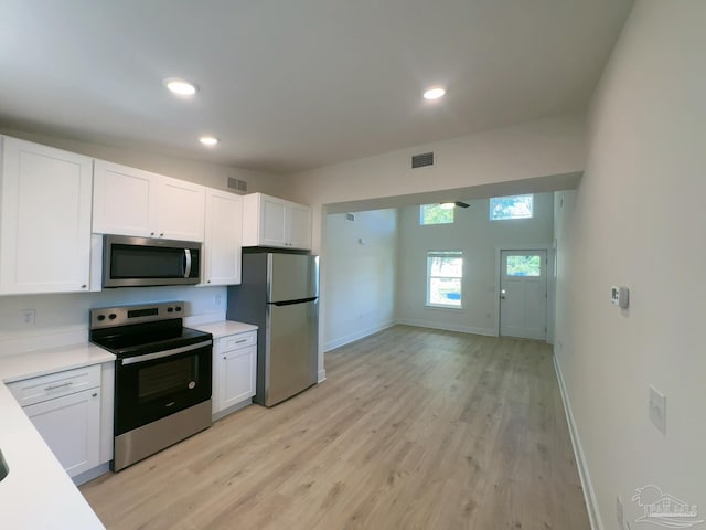 kitchen featuring white cabinets, visible vents, appliances with stainless steel finishes, and light countertops