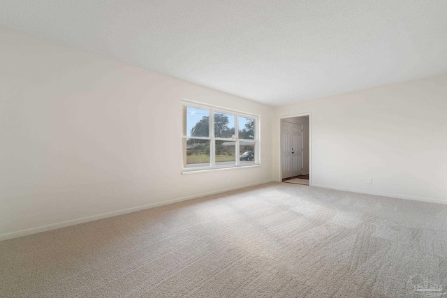 spare room with light carpet