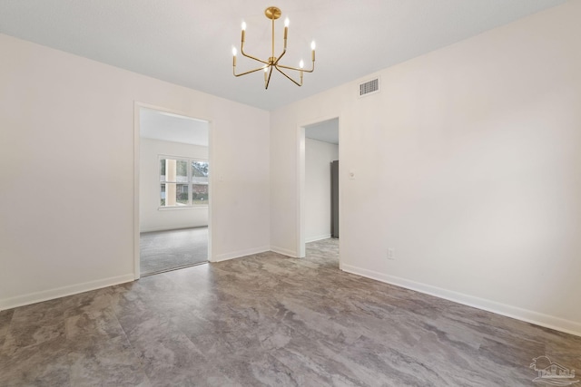 spare room with an inviting chandelier