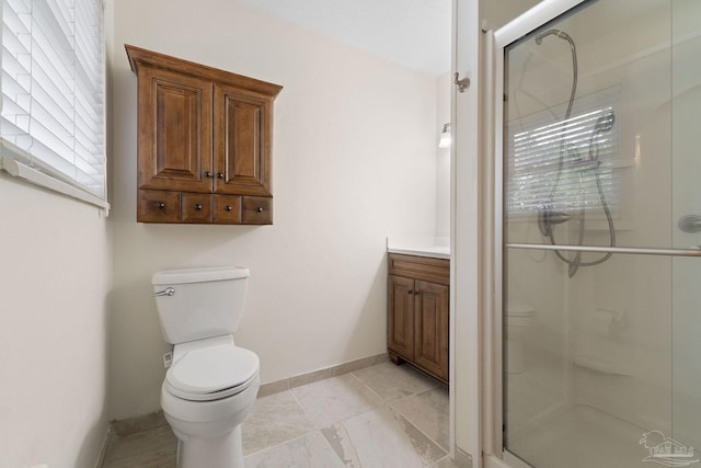 bathroom with vanity, toilet, and walk in shower