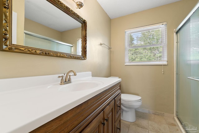 bathroom with vanity, toilet, and a shower with shower door