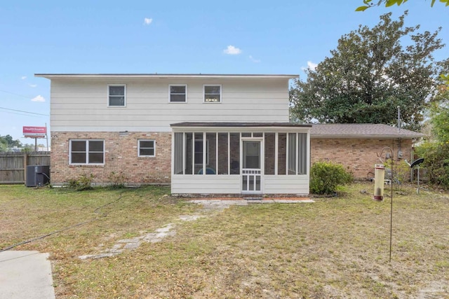 back of house with a sunroom, central AC unit, and a lawn